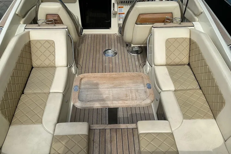  Yacht Photos Pics 2019 Chris-Craft Corsair 30 interior with beige quilted seating and wooden deck.
