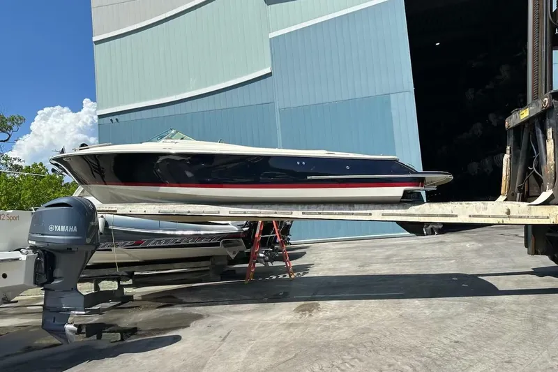  Yacht Photos Pics 2019 Chris-Craft Corsair 30 boat on forklift near large warehouse.