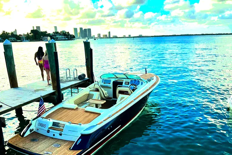  Yacht Photos Pics 2019 Chris-Craft Corsair 30 docked by a scenic waterfront with city skyline.