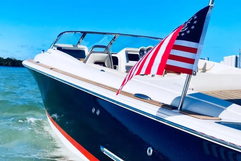  Yacht Photos Pics 2019 Chris-Craft Corsair 30 boat cruising on clear blue water with American flag.