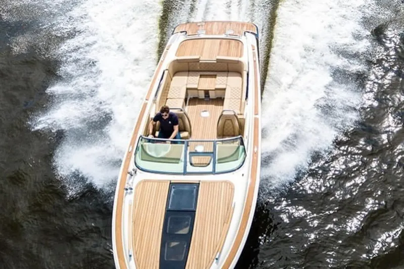  Yacht Photos Pics 2019 Chris-Craft Corsair 30 cruising on water, showcasing elegant design and wooden deck.
