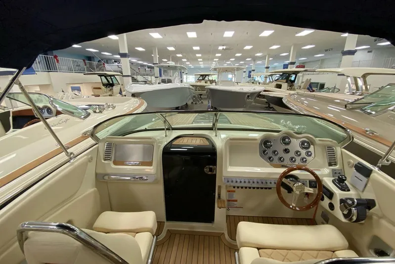  Yacht Photos Pics 2019 Chris-Craft Corsair 30 interior showcasing luxurious dashboard and steering wheel in showroom.