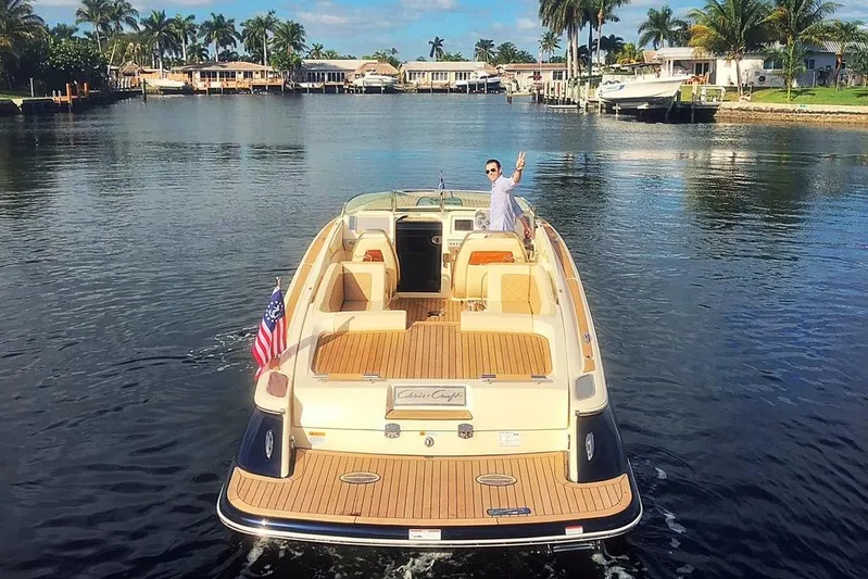  Yacht Photos Pics 2019 Chris-Craft Corsair 30 boat cruising on a scenic waterway with palm trees.