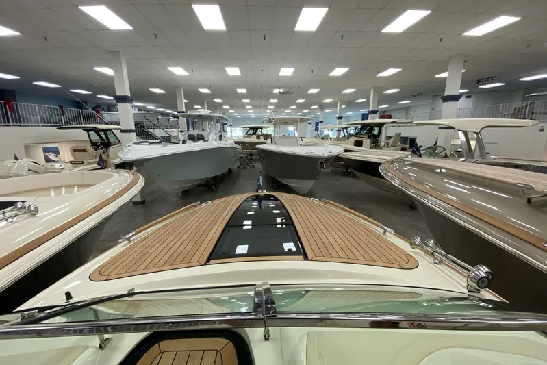  Yacht Photos Pics 2019 Chris-Craft Corsair 30 in showroom, surrounded by various luxury boats.
