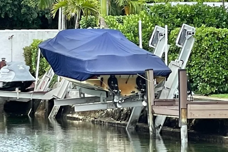  Yacht Photos Pics 2019 Chris-Craft Corsair 30 covered on a boat lift by the water.