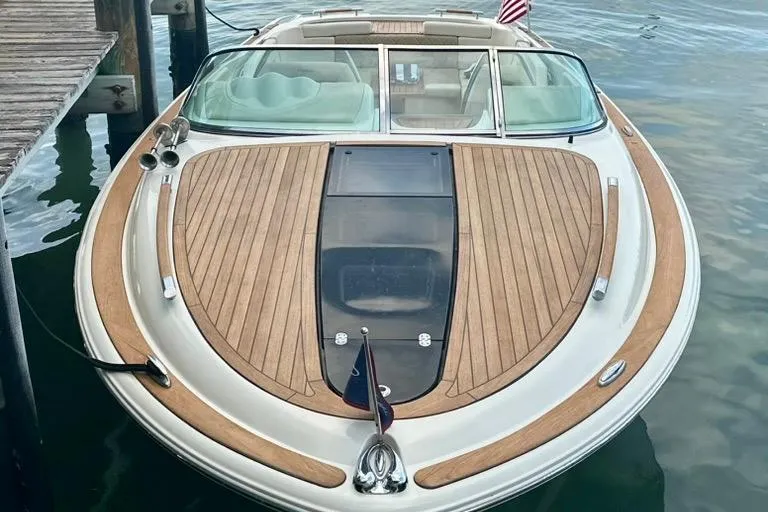 Yacht Photos Pics 2019 Chris-Craft Corsair 30 boat with elegant teak decking, docked by the water.