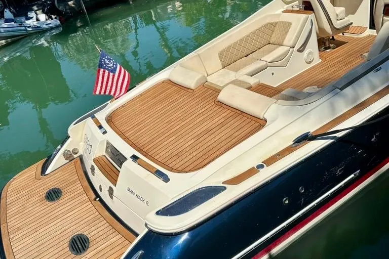  Yacht Photos Pics 2019 Chris-Craft Corsair 30 boat with teak deck and American flag in marina.