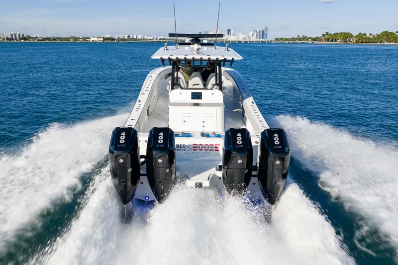 Red White And Booze Yacht Photos Pics Freeman 43 boat, 2022 model, with four powerful engines cruising on open water.