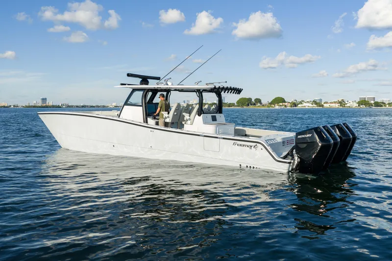 Red White And Booze Yacht Photos Pics 2022 Freeman 43 boat on water with multiple Mercury outboard engines.