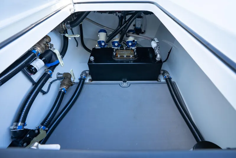 Red White And Booze Yacht Photos Pics Engine compartment of a 2022 Freeman 43 boat, showcasing hoses and components.