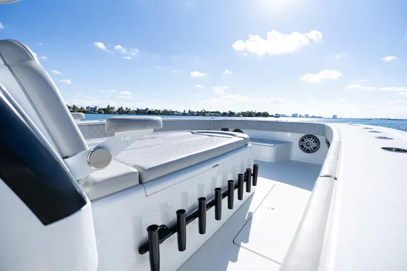 Red White And Booze Yacht Photos Pics 2022 Freeman 43 boat interior with seating and rod holders, under clear blue sky.