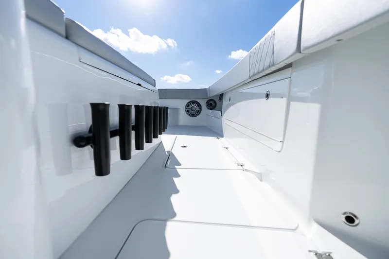 Red White And Booze Yacht Photos Pics 2022 Freeman 43 boat interior with rod holders and speakers under a clear blue sky.