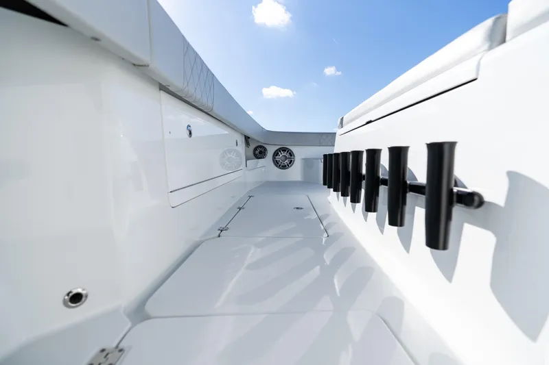 Red White And Booze Yacht Photos Pics 2022 Freeman 43 boat interior with rod holders and speakers under blue sky.