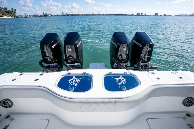 Red White And Booze Yacht Photos Pics 2022 Freeman 43 boat with four Mercury engines on a calm sea.