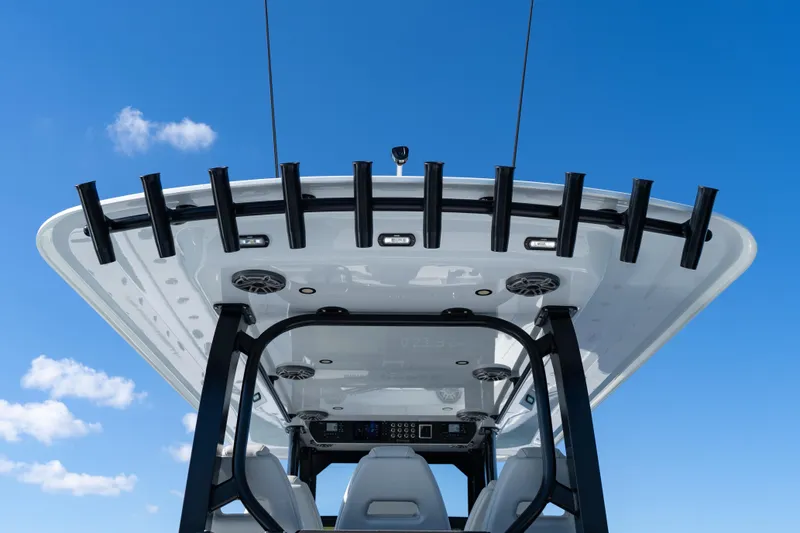 Red White And Booze Yacht Photos Pics 2022 Freeman 43 boat roof with rod holders against clear blue sky.