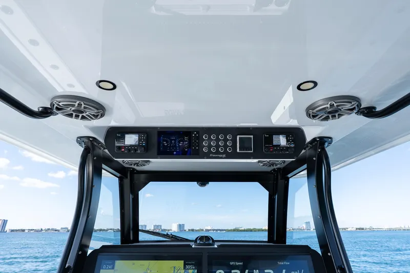 Red White And Booze Yacht Photos Pics 2022 Freeman 43 boat dashboard with navigation and control systems, ocean view in background.