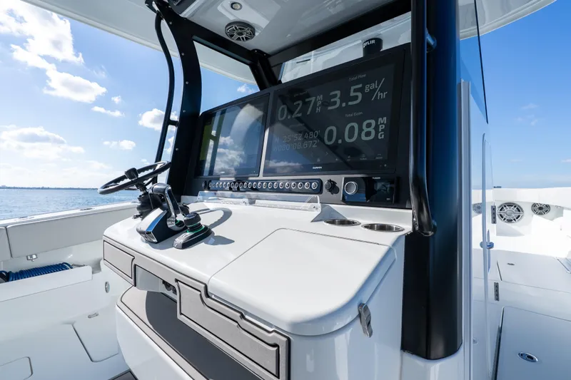 Red White And Booze Yacht Photos Pics Helm of 2022 Freeman 43 boat with digital display and controls, ocean view.