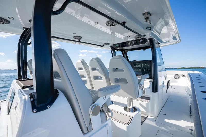 Red White And Booze Yacht Photos Pics Interior view of a 2022 Freeman 43 boat with modern seating and navigation equipment.