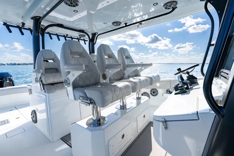 Red White And Booze Yacht Photos Pics Luxurious 2022 Freeman 43 boat interior with plush seating and modern controls on open water.