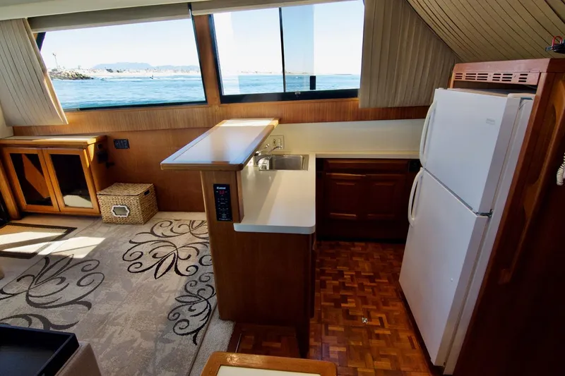 3 Hour Tour Yacht Photos Pics Interior of 1989 Viking Convertible yacht with kitchen, sink, and ocean view.