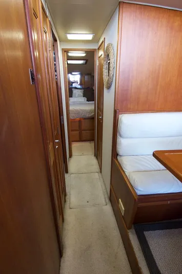 3 Hour Tour Yacht Photos Pics 1989 Viking Convertible yacht interior with wood paneling, hallway, and seating area.