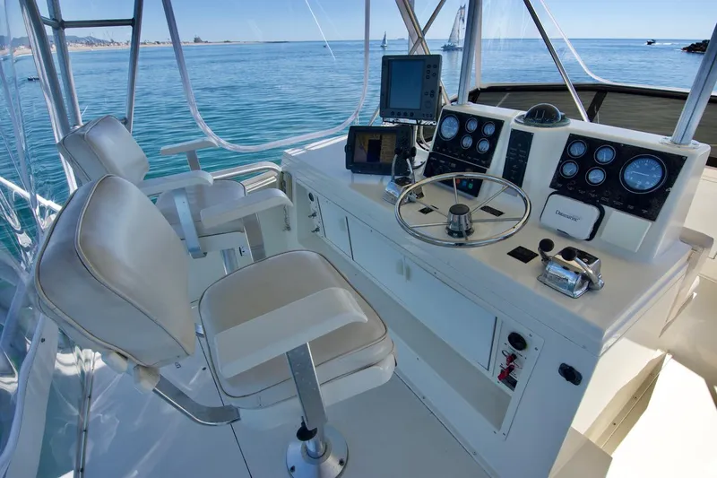 3 Hour Tour Yacht Photos Pics 1989 Viking Convertible yacht helm with steering wheel, navigation instruments, and ocean view.
