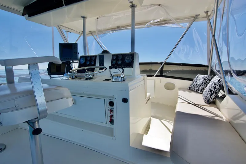 3 Hour Tour Yacht Photos Pics 1989 Viking Convertible yacht cockpit with steering wheel, seating, and navigation equipment.