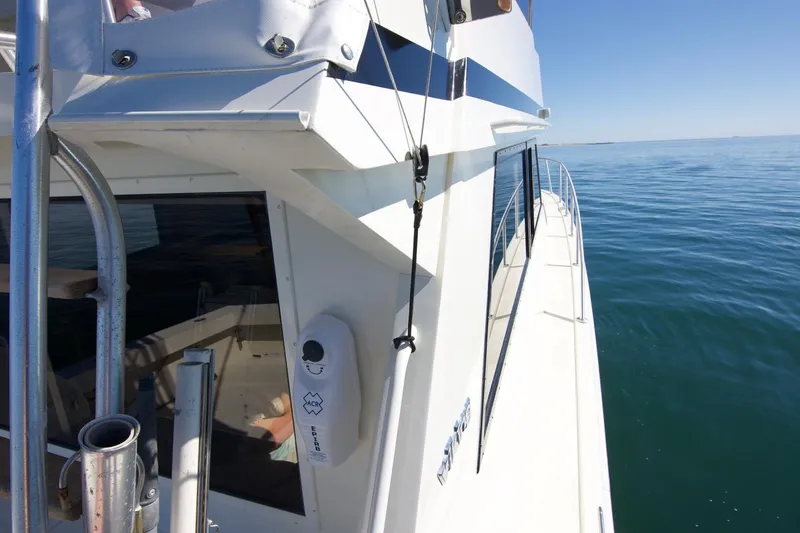 3 Hour Tour Yacht Photos Pics 1989 Viking Convertible yacht cruising on calm ocean waters under clear blue skies.