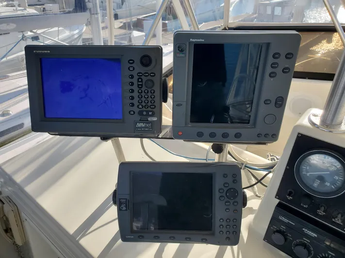 3 Hour Tour Yacht Photos Pics 1989 Viking Convertible boat navigation equipment with multiple display screens and controls.