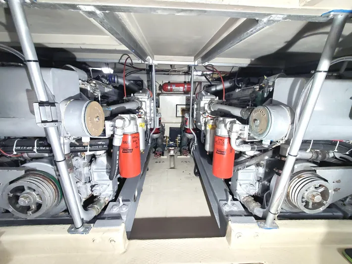 3 Hour Tour Yacht Photos Pics Engine room of a 1989 Viking Convertible boat, showcasing dual engines and mechanical components.