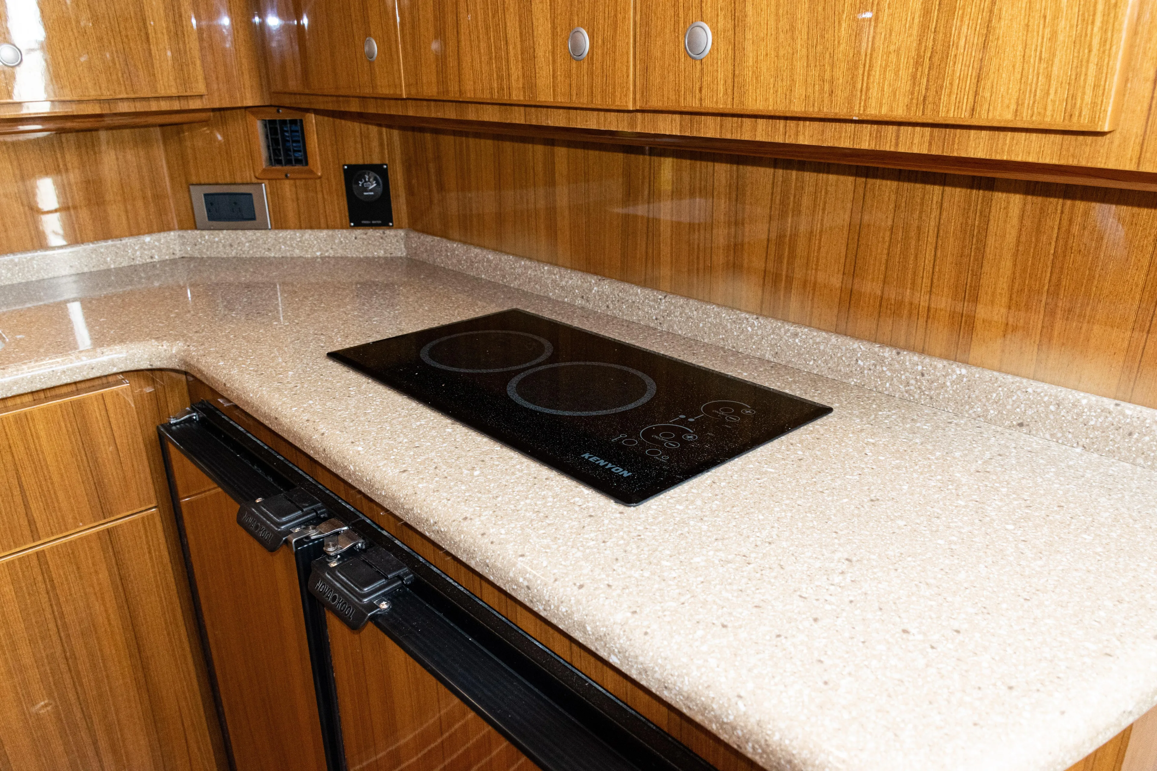  Yacht Photos Pics Luxurious kitchen interior of 2014 Viking 42 Express yacht with sleek countertops and modern cooktop.