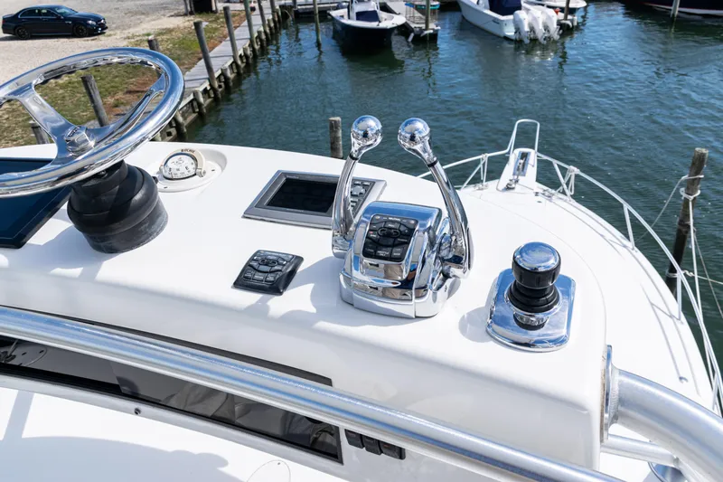  Yacht Photos Pics Helm controls of a 2014 Viking 42 Express yacht at a marina.