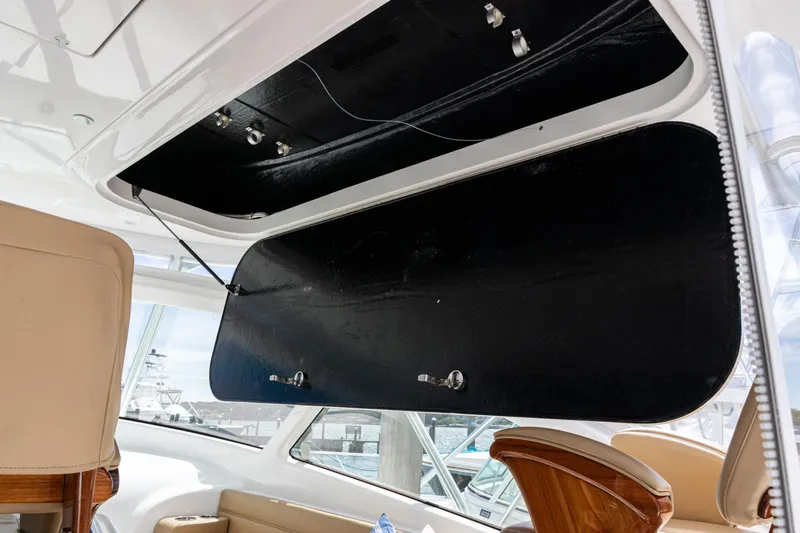  Yacht Photos Pics 2014 Viking 42 Express yacht interior with open storage compartment and beige seating.