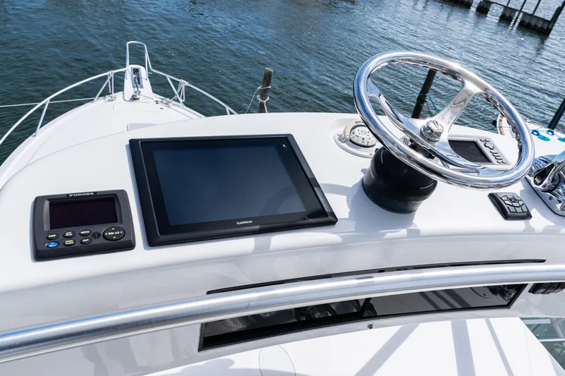  Yacht Photos Pics Helm of 2014 Viking 42 Express yacht with navigation equipment and steering wheel.