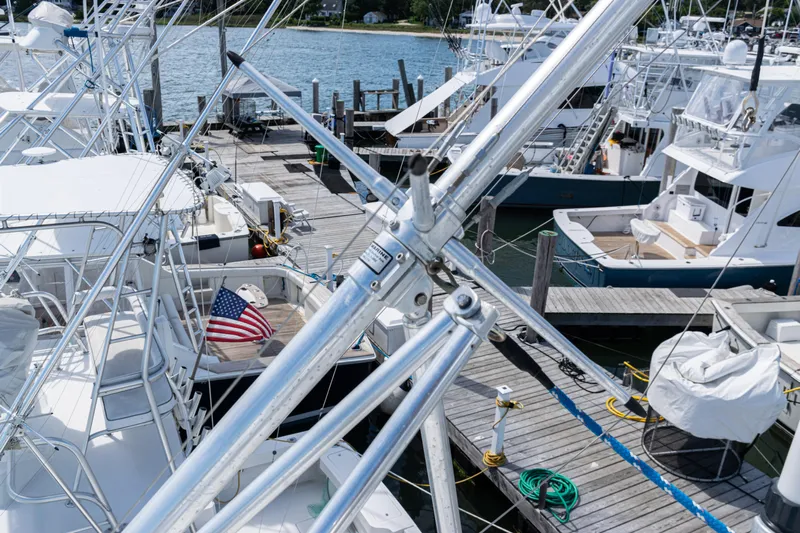  Yacht Photos Pics Boats docked at marina, featuring a 2014 Viking 42 Express yacht with American flag.