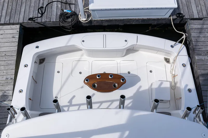  Yacht Photos Pics 2014 Viking 42 Express boat deck with fishing rod holders and wooden table.