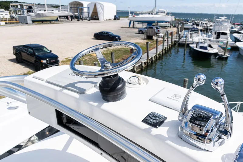  Yacht Photos Pics Helm of 2014 Viking 42 Express yacht at marina with boats and vehicles.