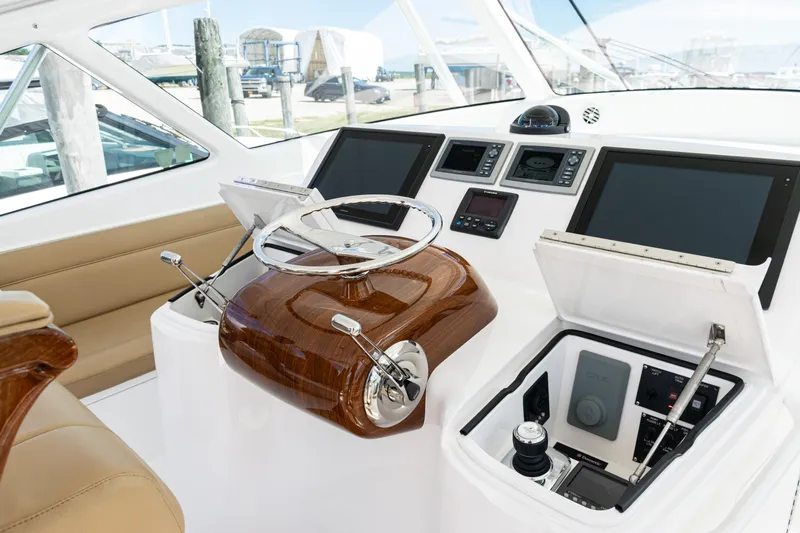  Yacht Photos Pics Interior helm of 2014 Viking 42 Express yacht with modern controls and navigation screens.