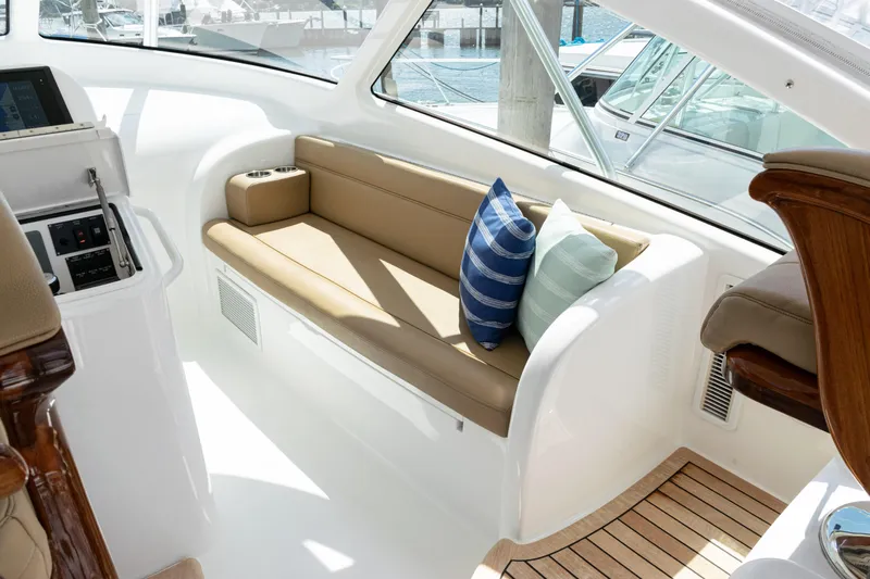  Yacht Photos Pics Interior of 2014 Viking 42 Express yacht with cushioned seating and striped pillows.