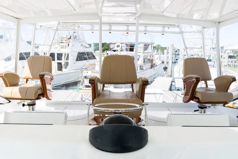  Yacht Photos Pics Interior view of 2014 Viking 42 Express yacht with three captain's chairs.