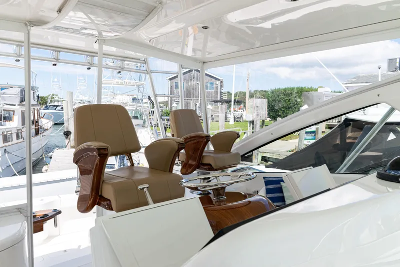  Yacht Photos Pics Interior view of 2014 Viking 42 Express yacht with luxurious seating and marina backdrop.