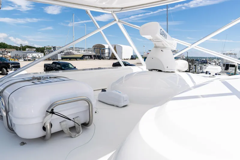  Yacht Photos Pics 2014 Viking 42 Express yacht deck with radar and life raft, docked at marina.