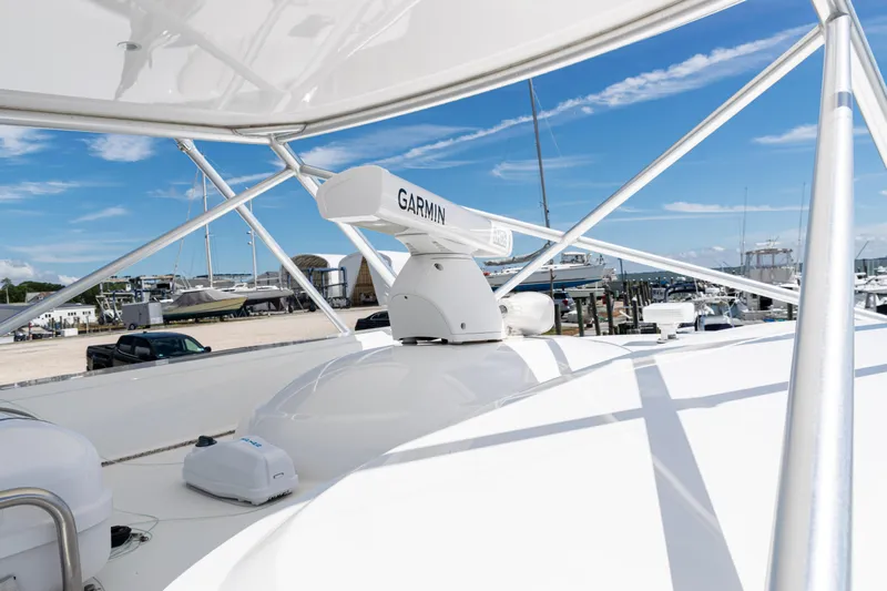  Yacht Photos Pics 2014 Viking 42 Express yacht with Garmin radar, docked at a marina under clear skies.