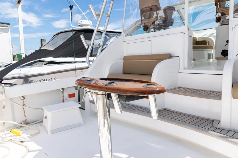  Yacht Photos Pics 2014 Viking 42 Express yacht with sleek seating and polished wood table on deck.