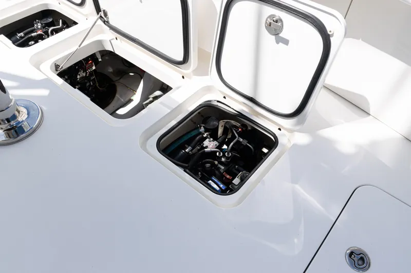  Yacht Photos Pics Open compartments on a 2014 Viking 42 Express boat deck, revealing mechanical components.