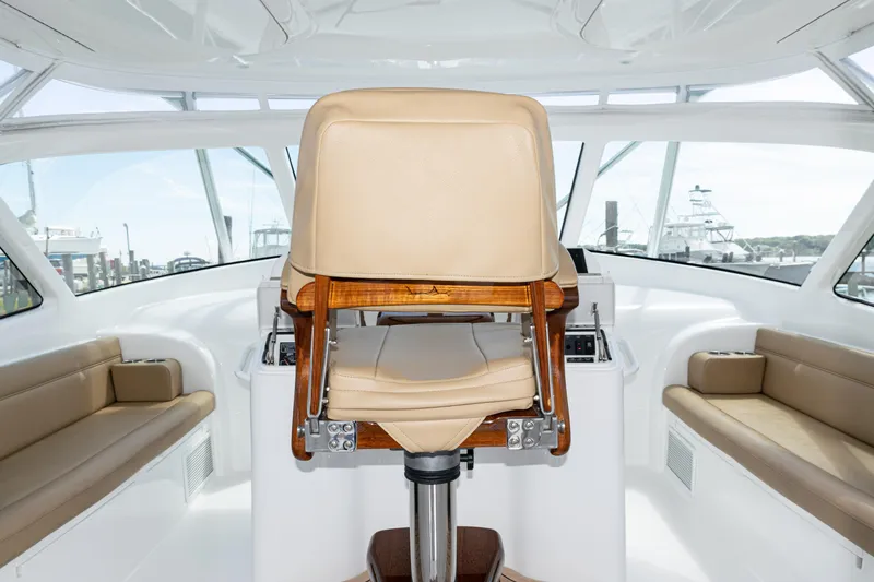  Yacht Photos Pics Interior of 2014 Viking 42 Express yacht with helm chair and seating area.