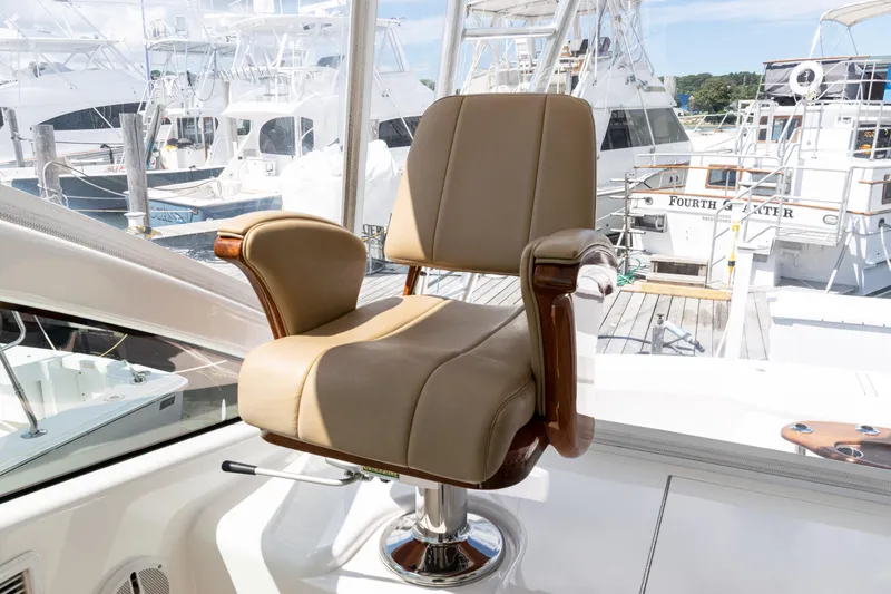  Yacht Photos Pics Captain's chair on 2014 Viking 42 Express yacht, docked at marina with other boats.