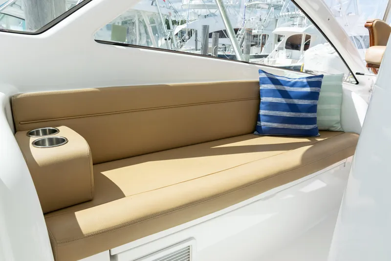  Yacht Photos Pics Luxurious seating area on 2014 Viking 42 Express yacht with striped cushions and cup holders.