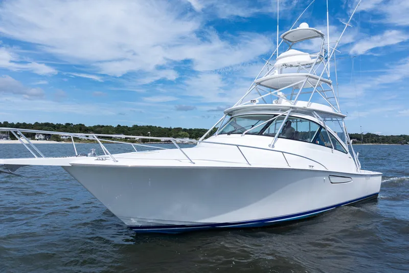  Yacht Photos Pics 2014 Viking 42 Express yacht cruising on open water under a clear blue sky.