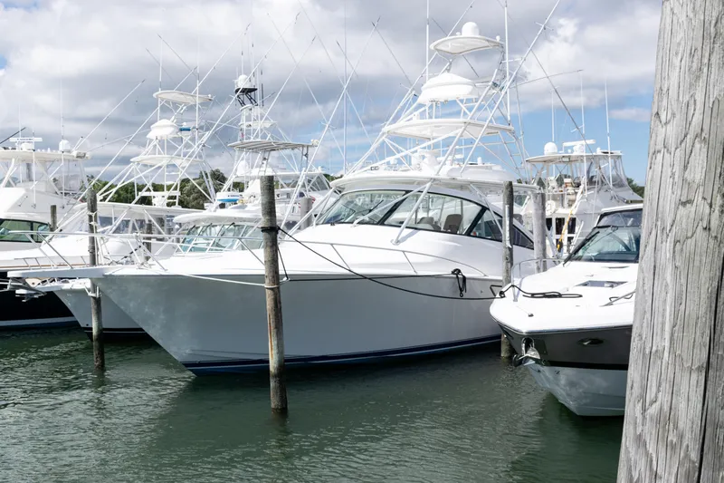  Yacht Photos Pics 2014 Viking 42 Express yacht docked among other boats under a cloudy sky.